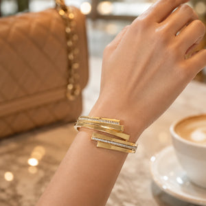 Side view of the gold layered stepped-bar cuff