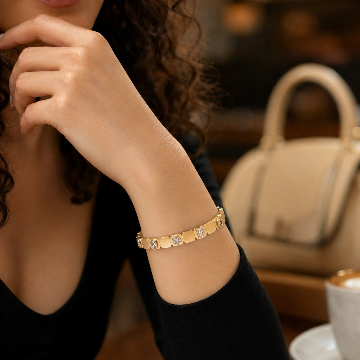 Gold mixed-cut crystal link bracelet on a dark jewellery studio display