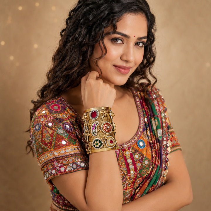 Gold multicolor Kundan handwork kada on a dark jewellery studio display