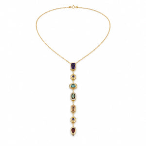 Gold multicolour Y necklace styled in an elegant jewellery flat lay