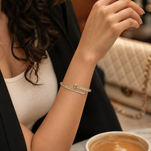 Gold nail-wrap crystal kada on a dark jewellery studio display