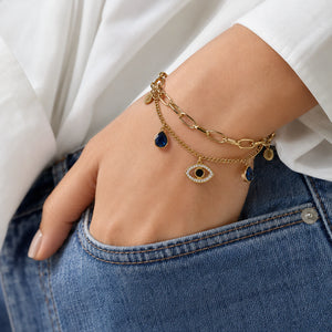 Angled view of the gold navy blue evil-eye bracelet