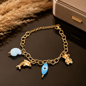Gold-tone ocean charm link bracelet with blue accent