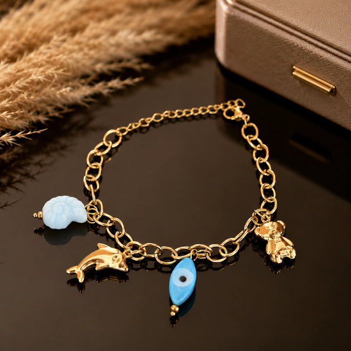 Gold-tone ocean charm link bracelet with blue accent