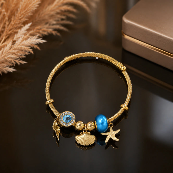 Gold-tone ocean charm twisted cable kada bracelet