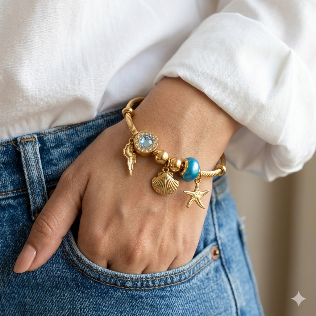 Side view of the gold ocean charm kada bracelet