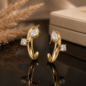 Gold open cuff hoops styled in an elegant jewellery flat lay