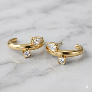 Side view of gold crystal-style open cuff hoop earrings