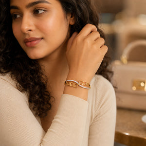 Gold open-square crystal hinged kada on a dark jewellery studio display