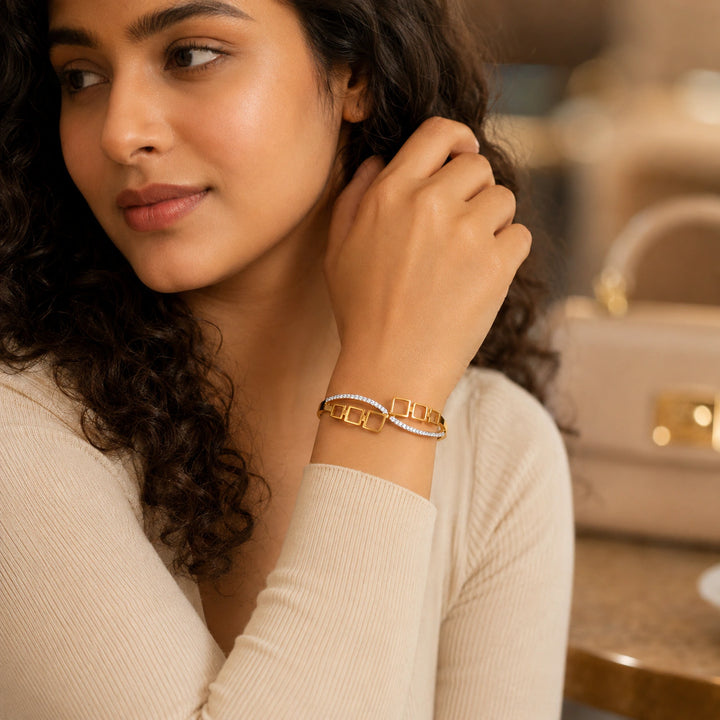 Gold open-square crystal hinged kada on a dark jewellery studio display