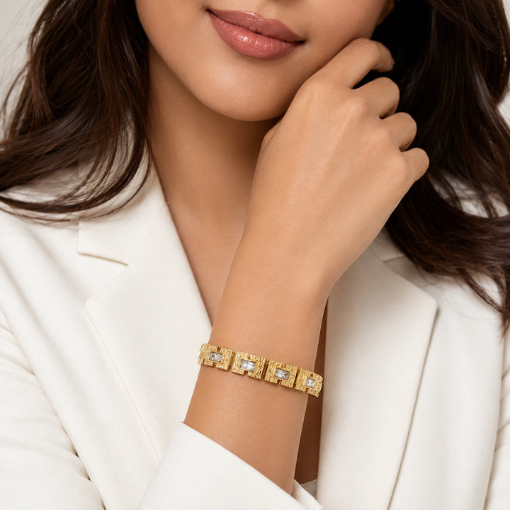 Gold openwork crystal kada on a dark jewellery studio display