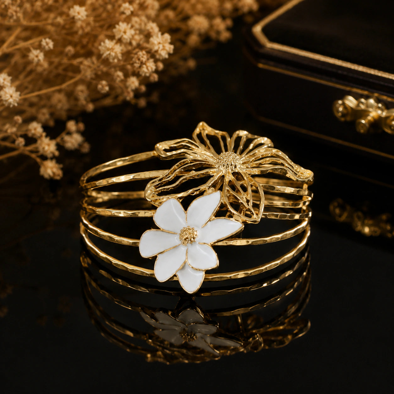 Gold openwork floral multi-band kada on a dark jewellery studio display
