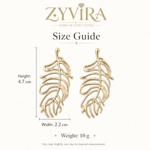 Angled view of gold openwork tropical leaf statement earrings