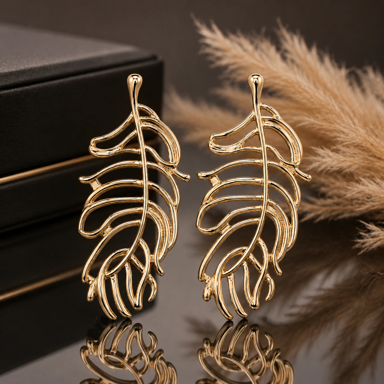 Gold openwork tropical leaf statement dangle earrings