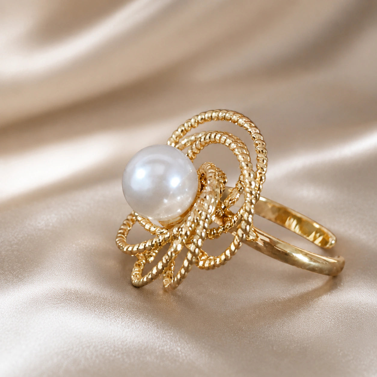 Angled view of the gold pearl beaded loop ring