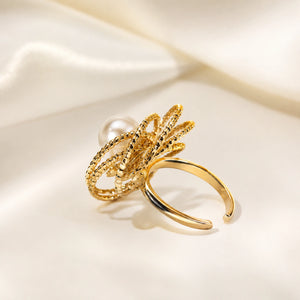 Gold pearl loop ring styled in an elegant jewellery flat lay