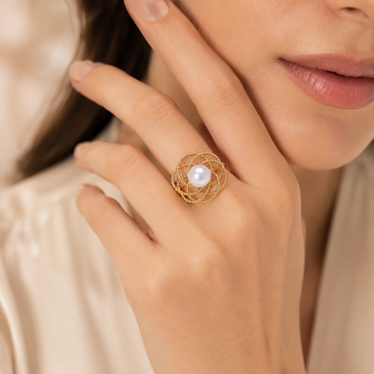 Close-up of pearl-style beads and loop ring detailing