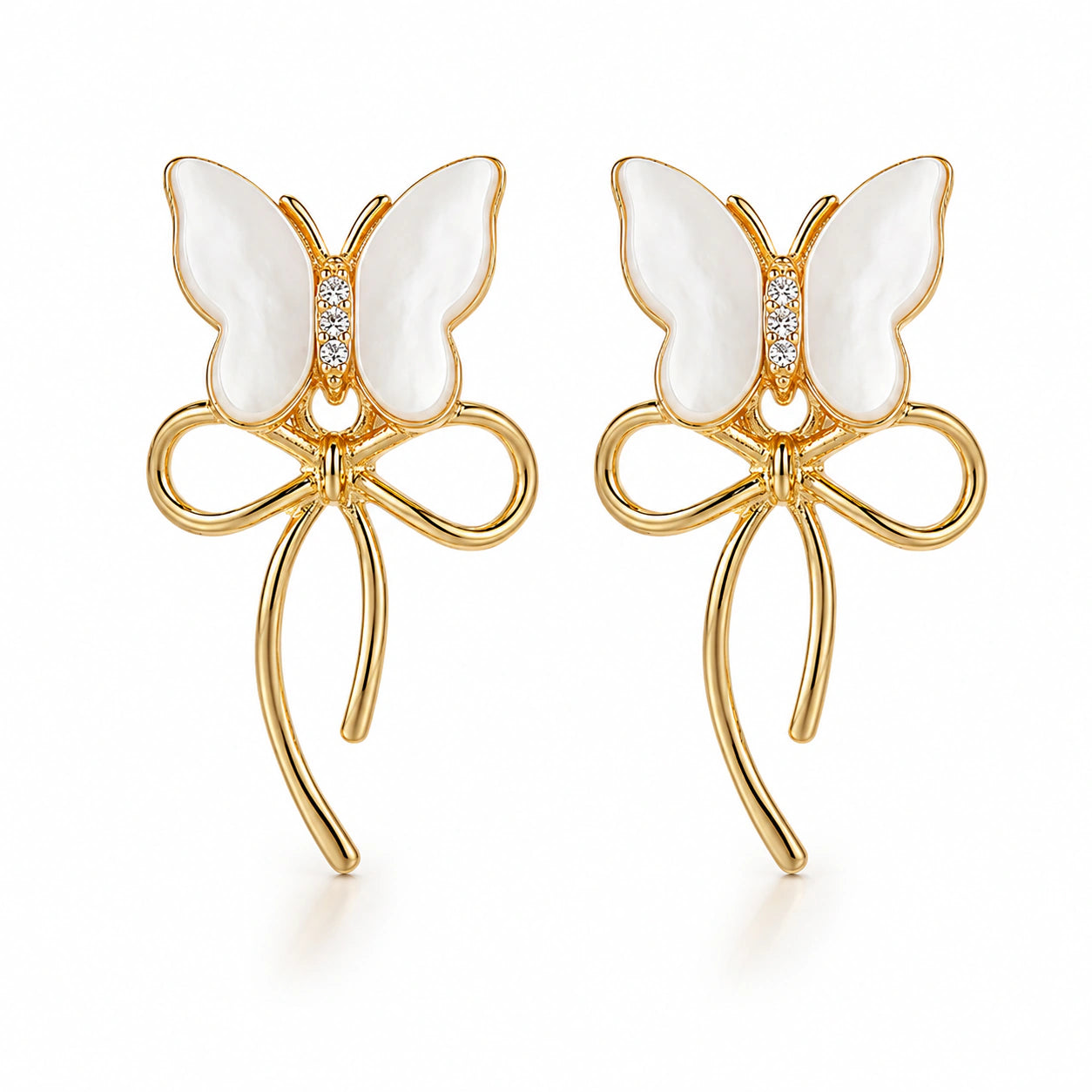 Angled view of gold pearl butterfly bow drop earrings