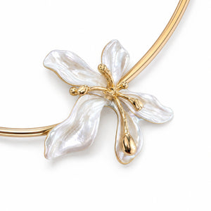 Gold pearl floral collar Hasali on a dark jewellery studio display
