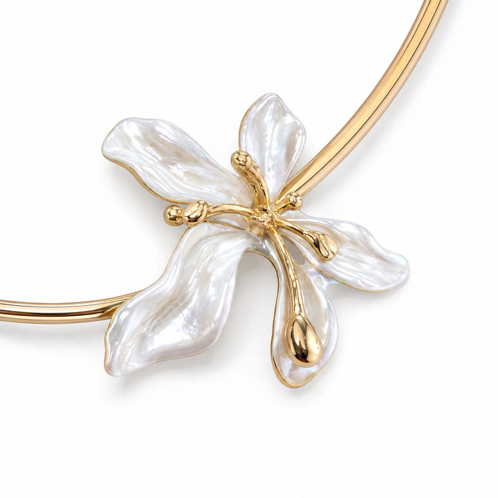 Gold pearl floral collar Hasali on a dark jewellery studio display
