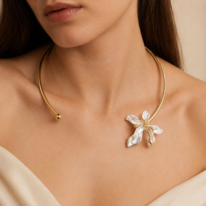 Close-up of pearl-style flowers and gold collar detailing