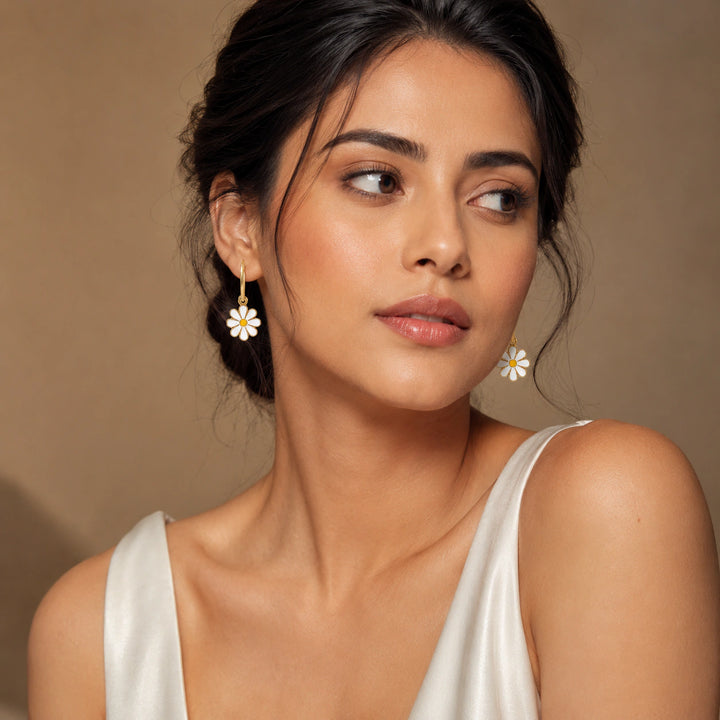 Gold pearl floral earring combo on a dark jewellery studio display
