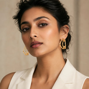 Close-up of pearl-style, floral and gold-tone earring details