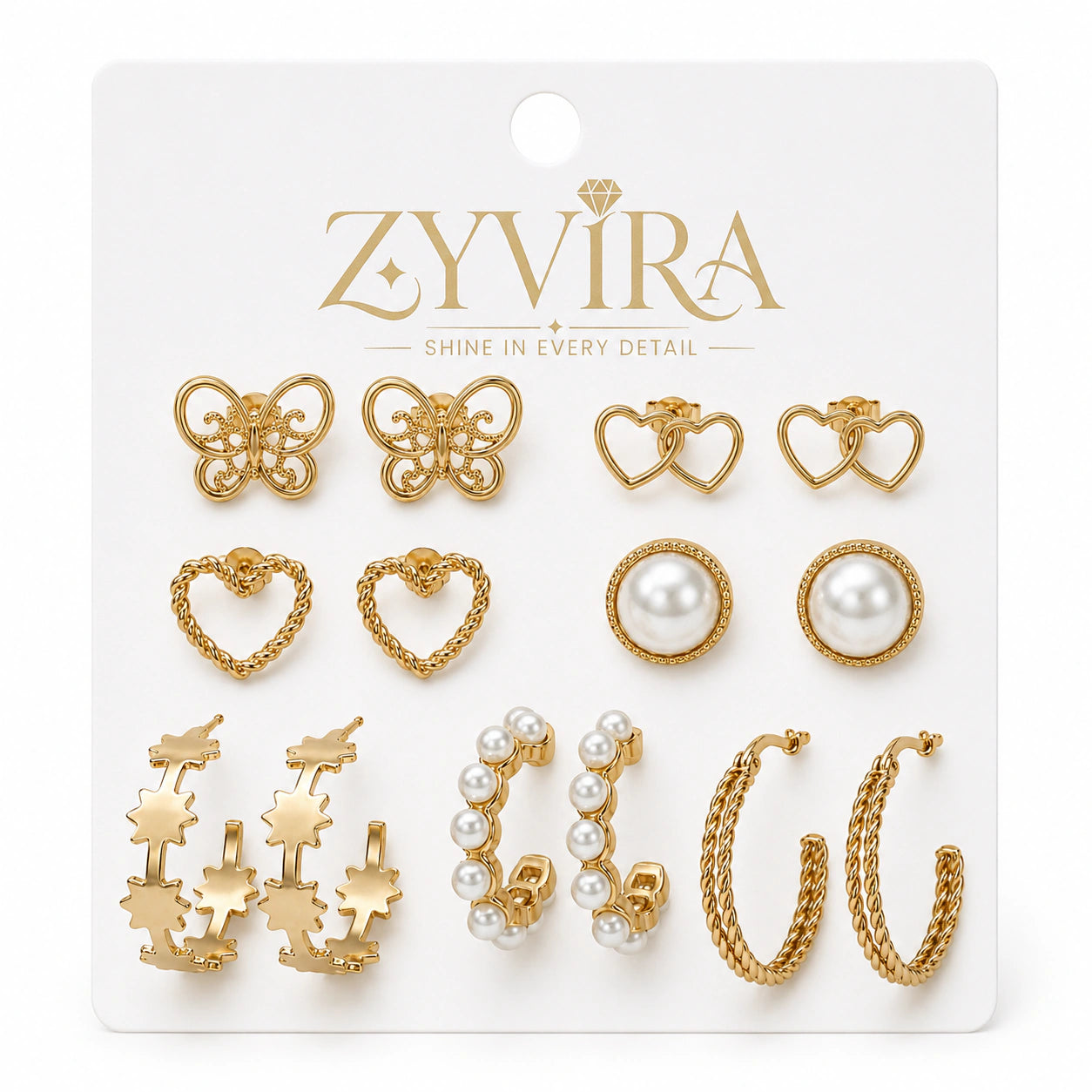Gold heart butterfly earring set styled in an elegant jewellery flat lay