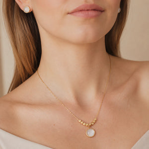 Gold pearl necklace set styled in an elegant jewellery flat lay