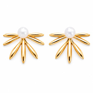 Gold pearl sunburst fan studs styled in an elegant jewellery flat lay