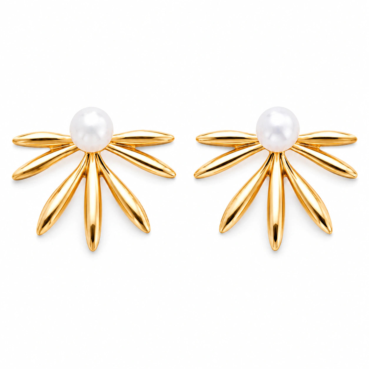 Gold pearl sunburst fan studs styled in an elegant jewellery flat lay
