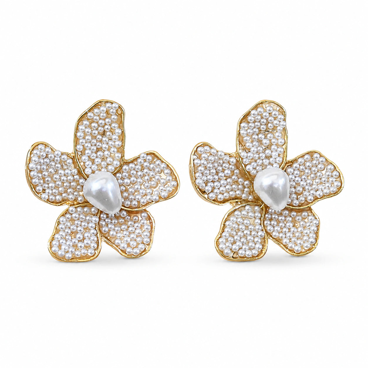 Close-up of sculpted floral petals and pearl-style teardrops