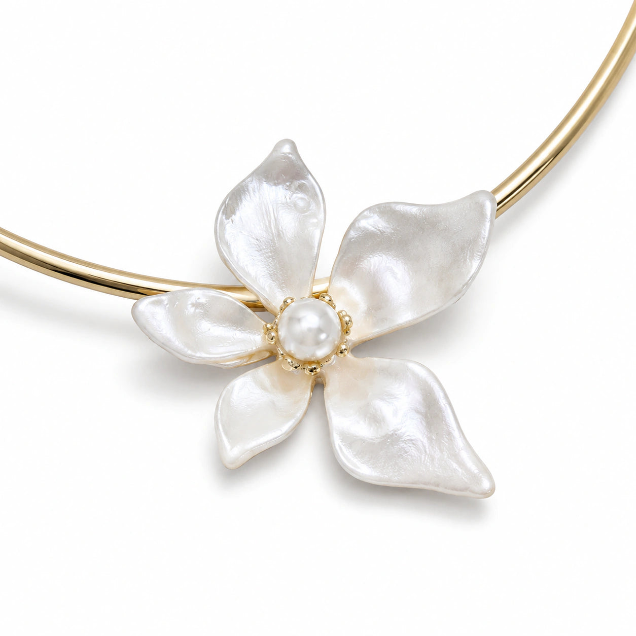 Gold pearl-white floral Hasali on a dark jewellery studio display