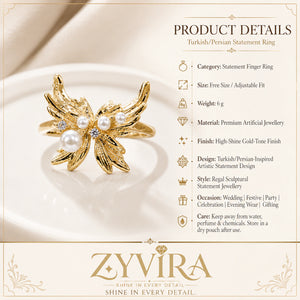 Gold pearl wing ring styled in an elegant jewellery flat lay