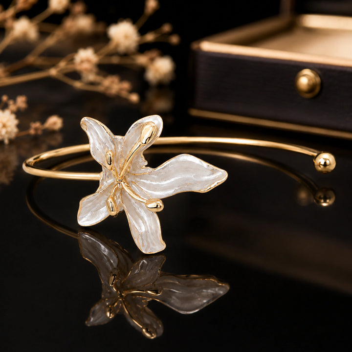 Gold pearly lily open kada on a dark jewellery studio display