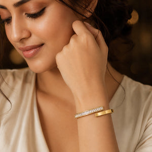 Angled view of the gold rectangular crystal open cuff