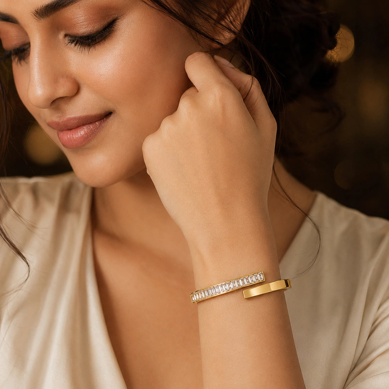 Angled view of the gold rectangular crystal open cuff