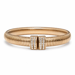 Angled view of the gold ribbed coil crystal cuff