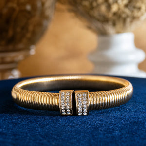 Side view of the gold ribbed coil crystal cuff