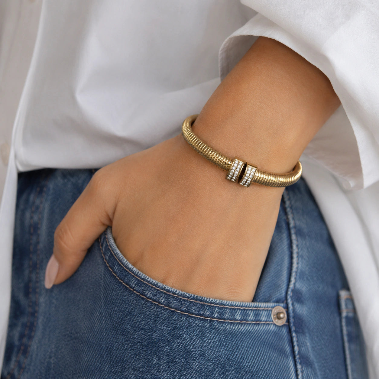 Top view of the gold ribbed coil crystal cuff