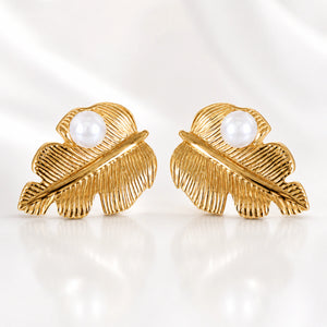 Gold ribbed leaf pearl studs styled in an elegant jewellery flat lay