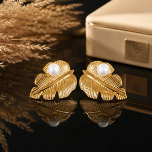 Close-up of ribbed gold leaves and pearl-style centres