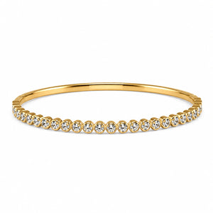 Close-up of round crystal bezels and gold bangle detailing