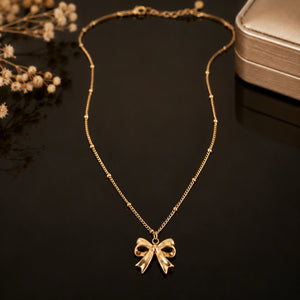 Alternate product view of the gold sculpted bow charm necklace