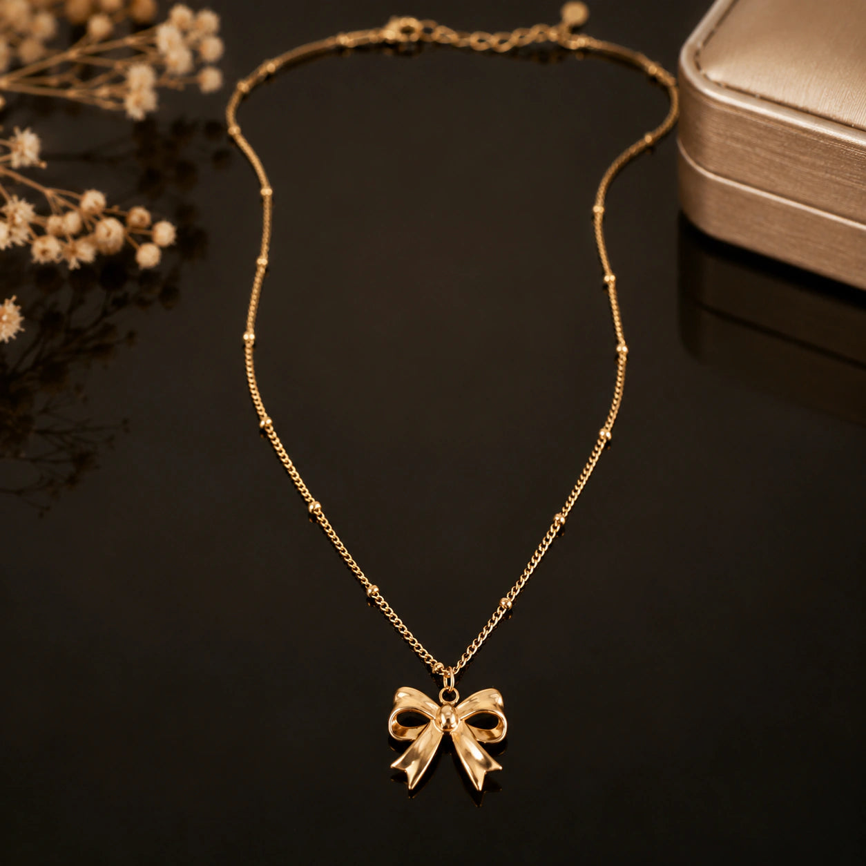 Alternate product view of the gold sculpted bow charm necklace