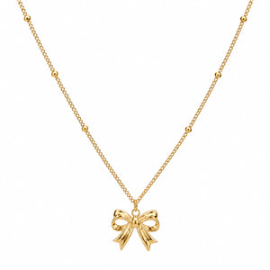 Angled view of the gold sculpted bow charm necklace