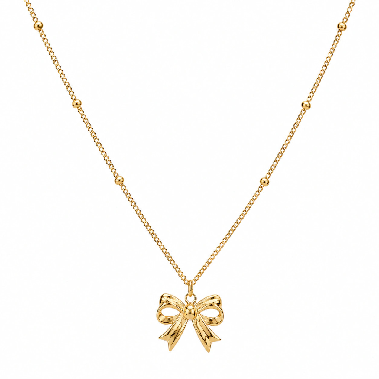 Angled view of the gold sculpted bow charm necklace