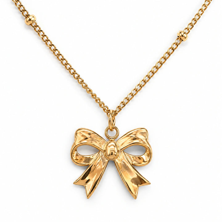 Gold-tone sculpted bow charm pendant necklace