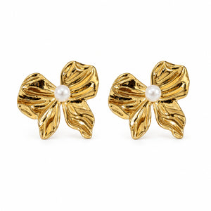 Close-up of sculpted gold petals and pearl-style flower centres