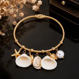Close-up of shell, starfish and pearl-style charm detailing